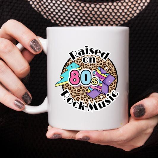 Tasse Raised on 80ies Rock Music Frau hält Tasse Produktfoto